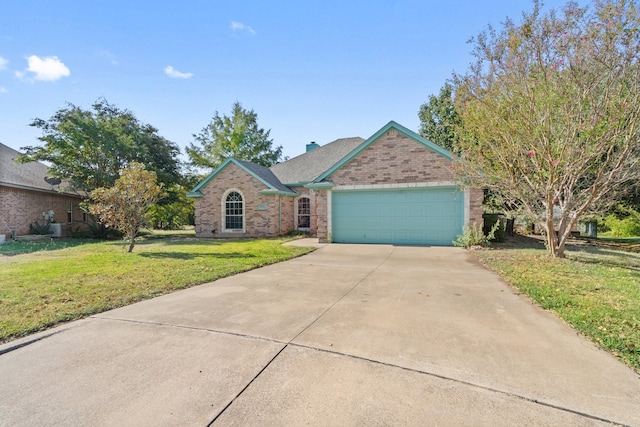 view of front of property with a garage and a front lawn