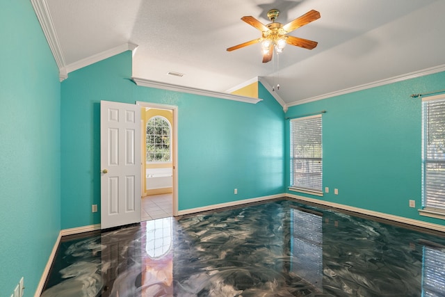 spare room with crown molding, vaulted ceiling, and ceiling fan