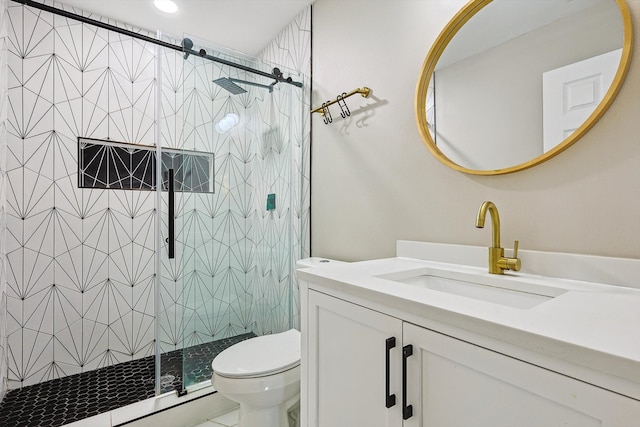 bathroom with toilet, an enclosed shower, and vanity