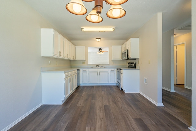 kitchen with dark hardwood / wood-style floors, stainless steel appliances, sink, white cabinetry, and ceiling fan