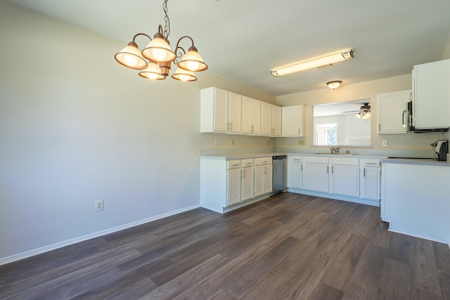 kitchen featuring white cabinets, dark wood-type flooring, ceiling fan with notable chandelier, and pendant lighting