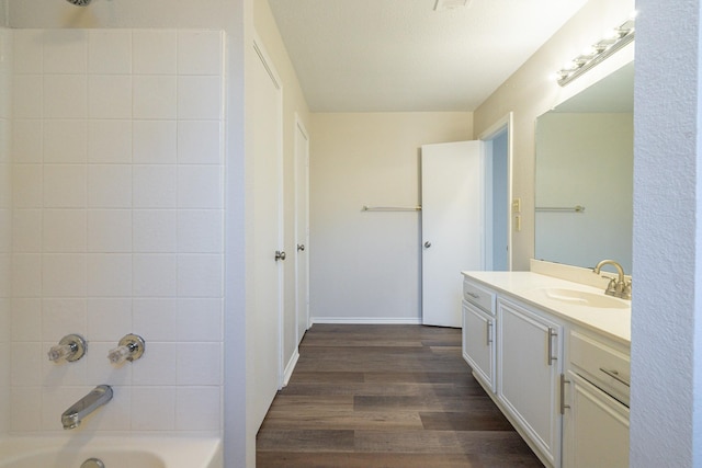 bathroom with vanity, bathtub / shower combination, and wood finished floors