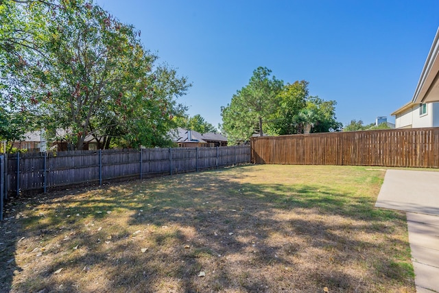 view of yard featuring a patio area and a fenced backyard