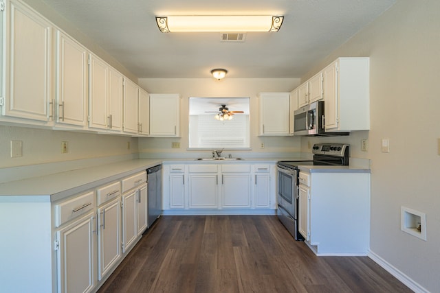 kitchen with sink, white cabinetry, dark hardwood / wood-style flooring, appliances with stainless steel finishes, and ceiling fan