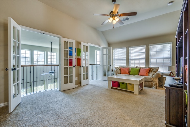 carpeted living room with lofted ceiling, french doors, and ceiling fan