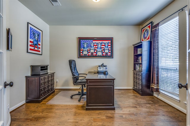 office space featuring dark wood-type flooring and a healthy amount of sunlight