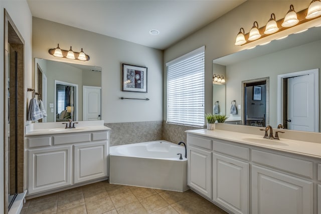 bathroom featuring vanity, shower with separate bathtub, and tile patterned flooring