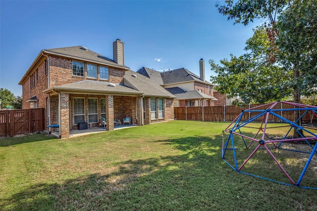 back of property with a patio and a yard