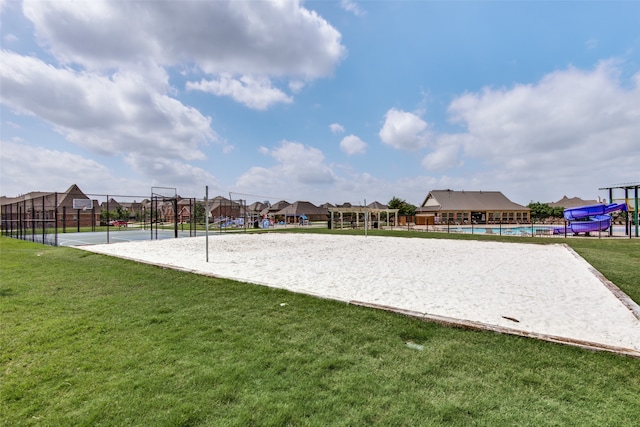 view of property's community with a yard, a playground, and volleyball court