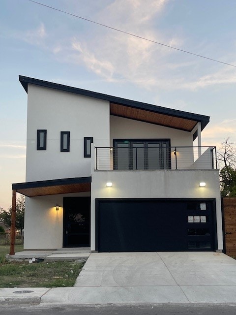 contemporary house featuring a balcony and a garage