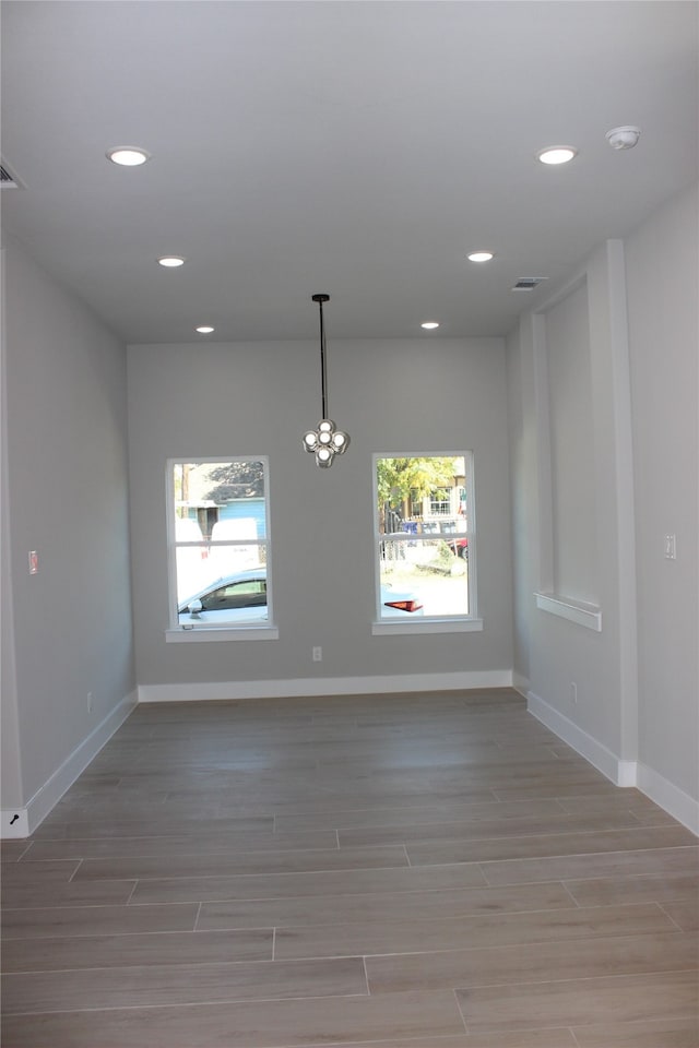 spare room with hardwood / wood-style floors