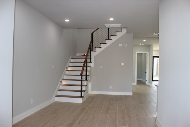 stairs featuring hardwood / wood-style flooring