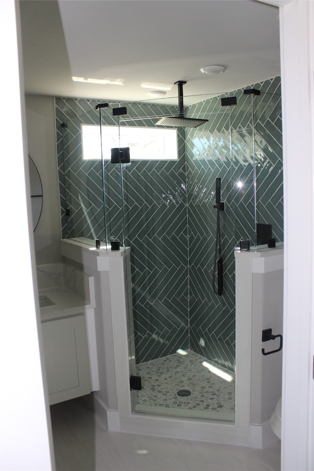 bathroom featuring vanity and an enclosed shower