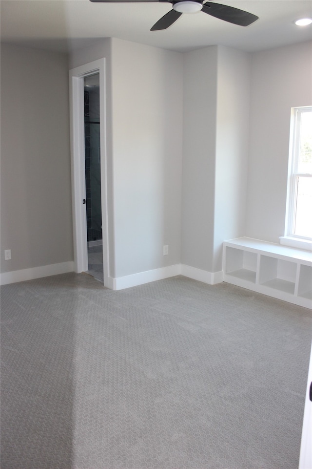 spare room with carpet flooring and ceiling fan