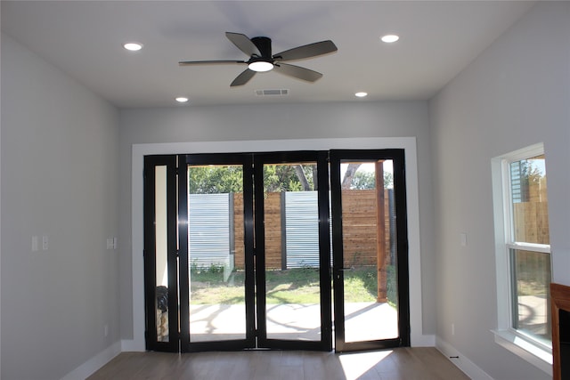 doorway to outside with ceiling fan and wood-type flooring