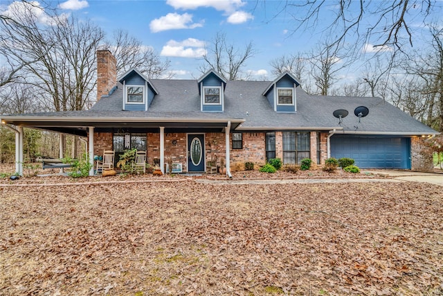 view of front of home with concrete driveway, brick siding, a chimney, and an attached garage