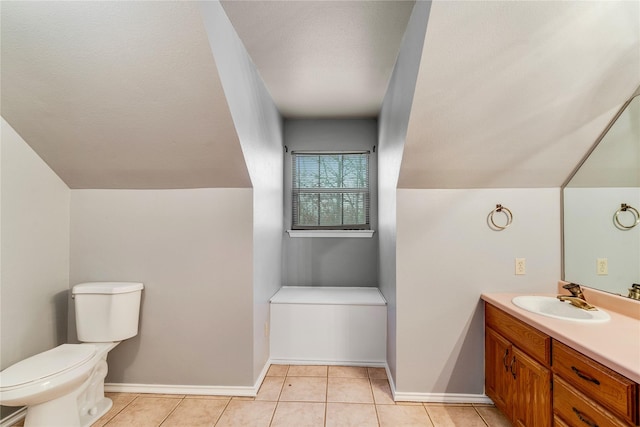 bathroom featuring baseboards, toilet, vanity, and tile patterned floors