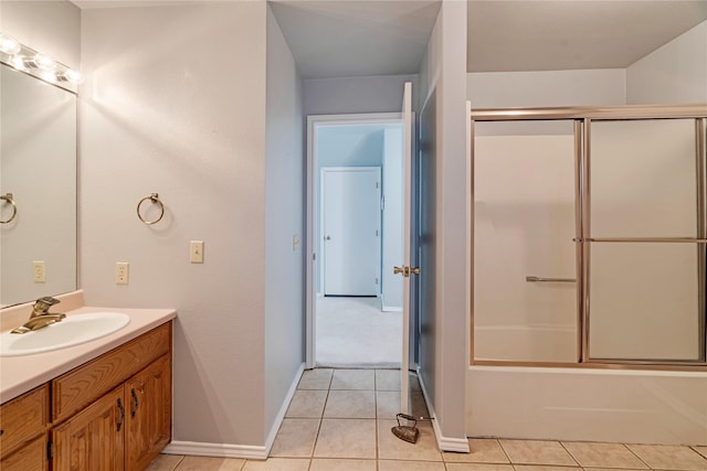 bathroom with tile patterned flooring, shower / bath combination with glass door, vanity, and baseboards