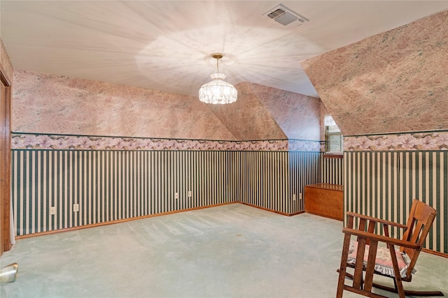 unfurnished room with carpet floors, lofted ceiling, and visible vents