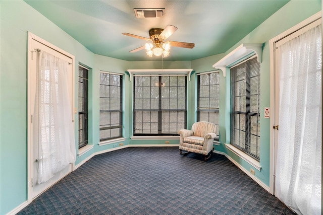 unfurnished room featuring ceiling fan, carpet floors, visible vents, and baseboards