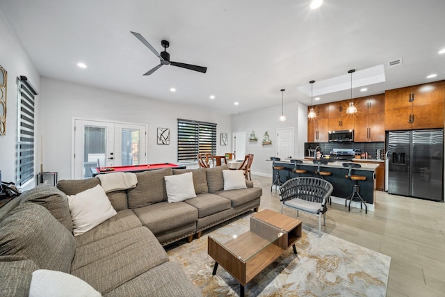 living room with french doors, ceiling fan, and pool table