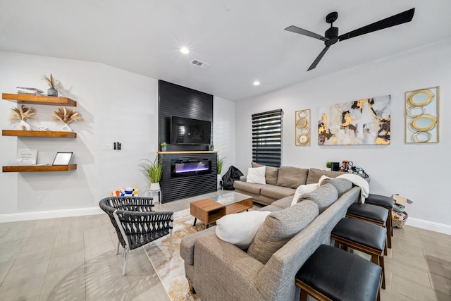 living room featuring ceiling fan and a fireplace