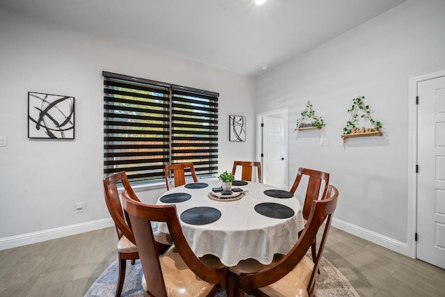 dining area with hardwood / wood-style floors