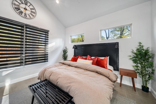 bedroom featuring multiple windows and lofted ceiling