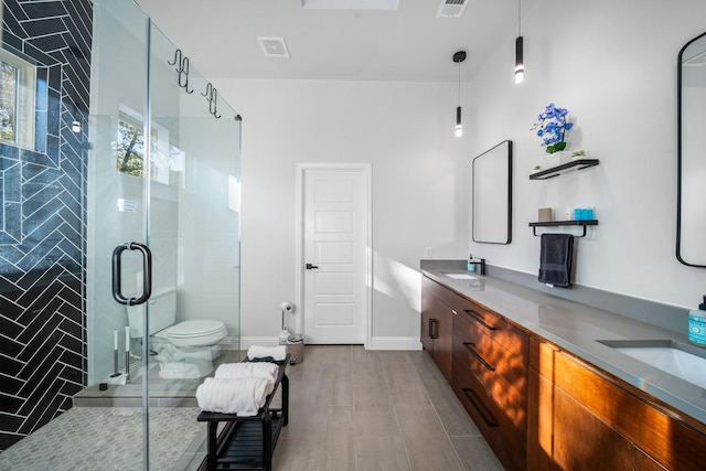 bathroom with wood-type flooring, vanity, toilet, and a shower with shower door