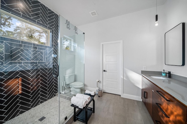 bathroom featuring hardwood / wood-style floors, vanity, toilet, and a shower with door