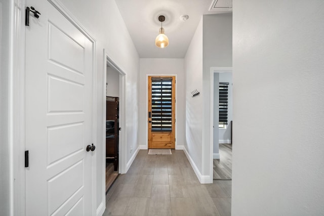 hall with light hardwood / wood-style floors