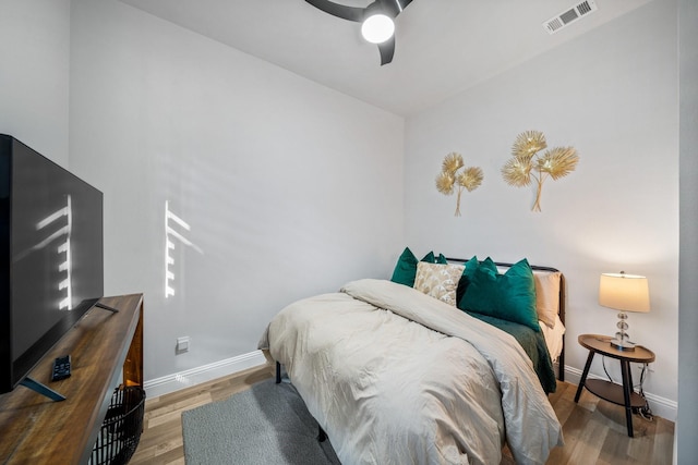 bedroom with hardwood / wood-style flooring and ceiling fan