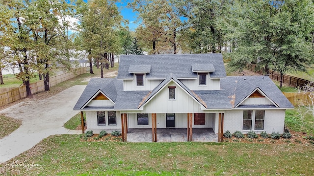 view of front of house with a patio area and a front lawn