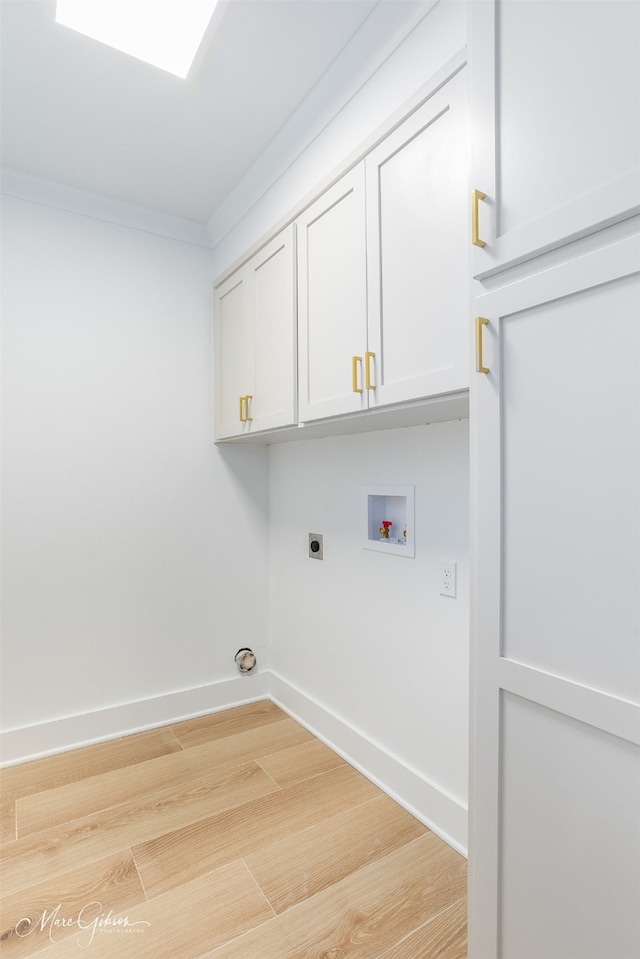 laundry room with hardwood / wood-style flooring, electric dryer hookup, cabinets, washer hookup, and ornamental molding