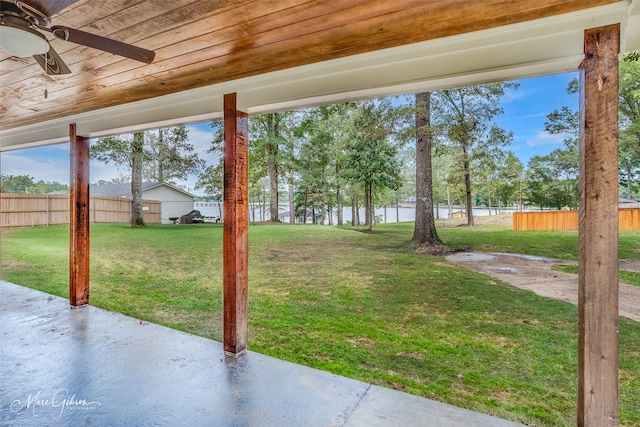 view of yard with ceiling fan and a patio area