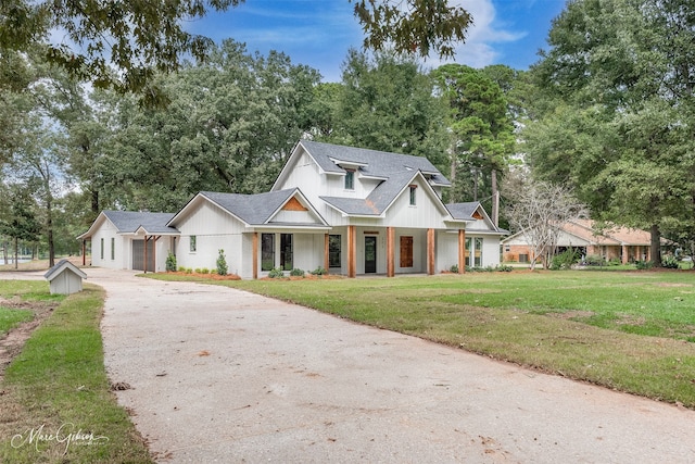 modern farmhouse with covered porch and a front yard