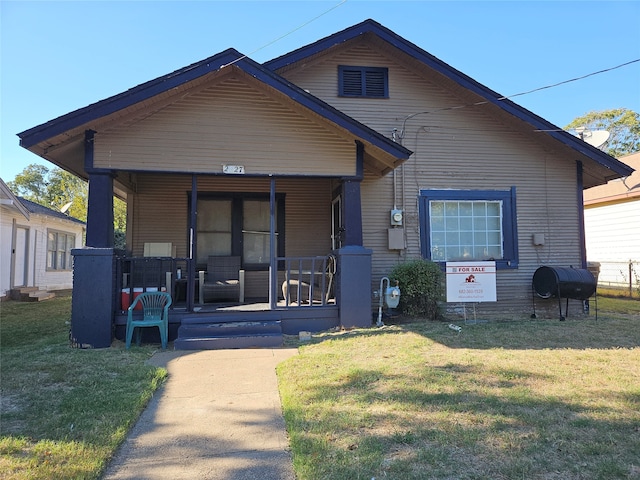 bungalow featuring a front yard and a porch