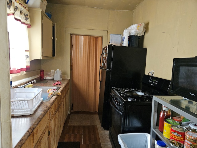 kitchen featuring black gas range and sink