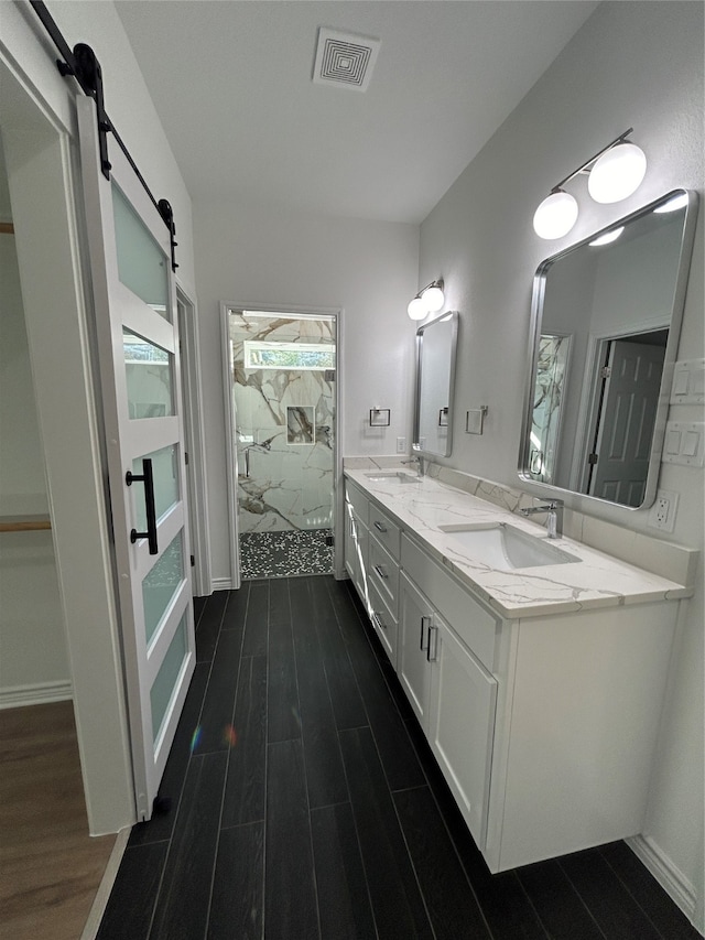 bathroom with vanity, wood-type flooring, and walk in shower