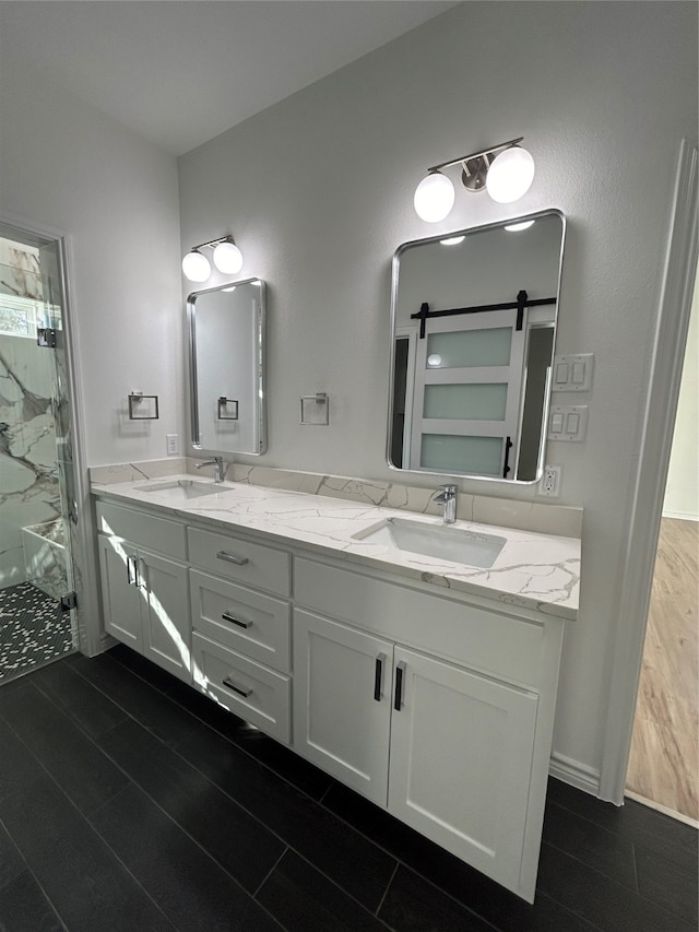 bathroom with vanity, hardwood / wood-style flooring, and a shower with door