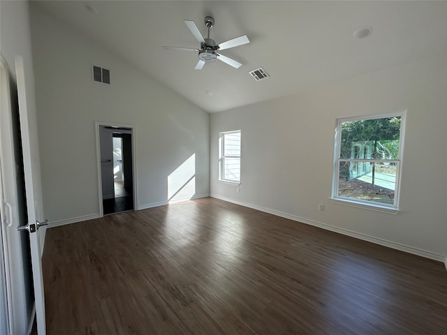 empty room with high vaulted ceiling, dark hardwood / wood-style floors, a healthy amount of sunlight, and ceiling fan