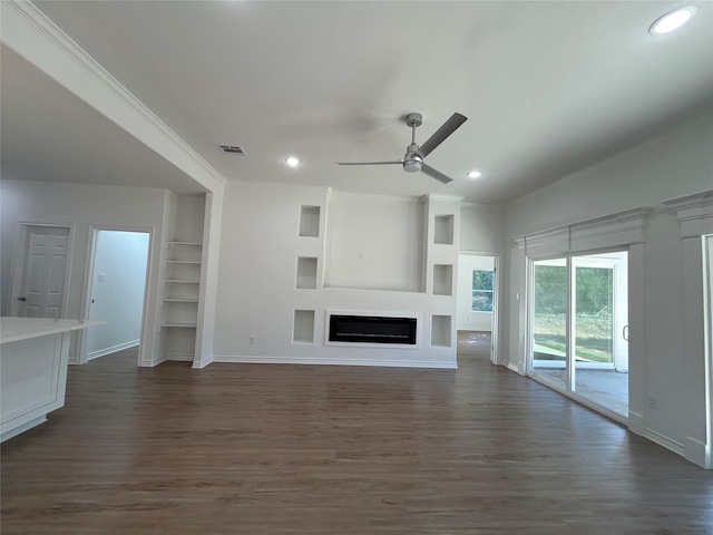 unfurnished living room with ceiling fan, crown molding, and dark wood-type flooring