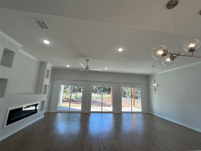 unfurnished living room featuring ceiling fan, dark wood-type flooring, and ornamental molding