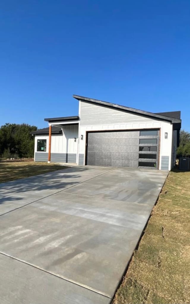 view of front of house with central AC and a garage