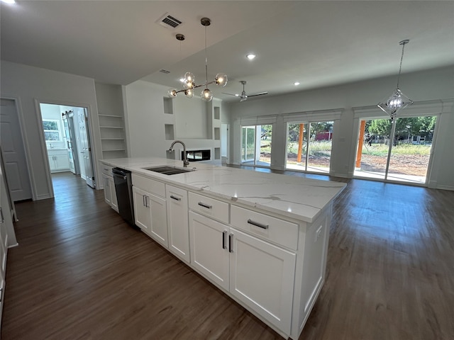 kitchen with white cabinetry, dishwasher, sink, hanging light fixtures, and an island with sink