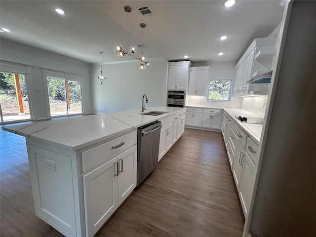 kitchen featuring a large island with sink, sink, dark hardwood / wood-style flooring, white cabinetry, and stainless steel appliances