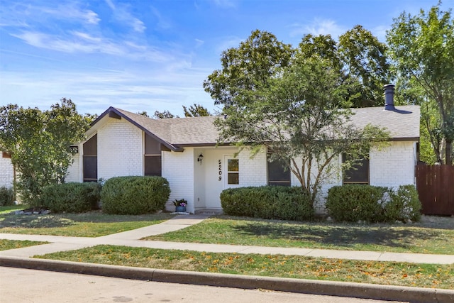 ranch-style home featuring a front yard