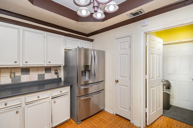 kitchen with light parquet flooring, stainless steel fridge with ice dispenser, and white cabinets