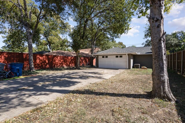 view of front facade with a garage and central air condition unit