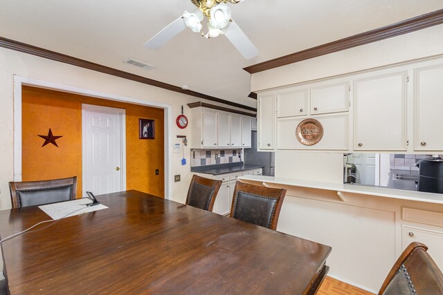 dining space featuring ceiling fan and ornamental molding